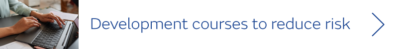 Person typing on laptop - text: Development courses to reduce risk